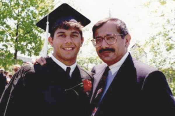 Pictured with his father at Commencement, Edward Estrada '94 named his endowed scholarship after his father, Robert K. Estrada, as a tribute. The scholarship benefits first-generation students at the College of Arts and Sciences.