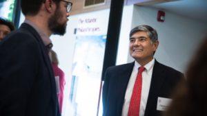 Christopher Oechsli, president and CEO of The Atlantic Philanthropies, right, chats with Erik Herter, principal of Herter Design Group, at the Martin Y. Tang Welcome Center during the Sept. 14 dedication event. Herter's firm designed the exhibit space in the new center.