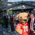 Martin Tang with the Big Red Bear at the official dedication of the Martin Y. Tang Welcome Center.