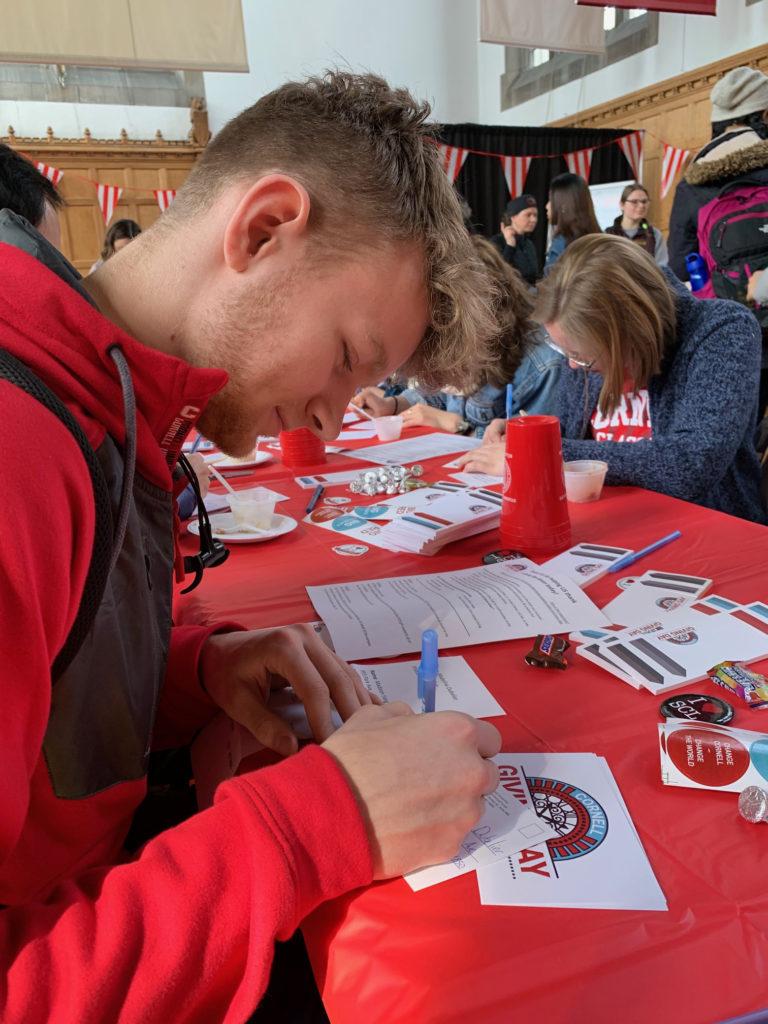 First-year student Fridrik Diehl, Class of 2022, writing thank-you cards to Giving Day donors. 