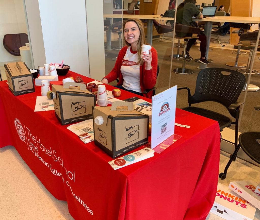 Karinna Browning, Class of 2017, works as a program assistant in the School of Hotel Administration, and her Giving Day job was to share goodwill, donuts, apples, and coffee with students on their way to morning classes.