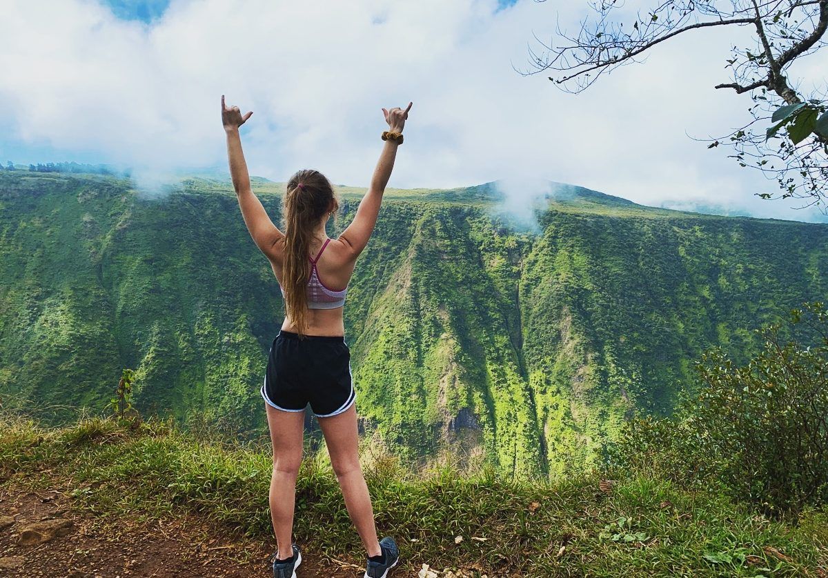 Boucher raises two shakas in triumph after completing a hike in Waipio Valley in her hometown of Waimea, Hawaii.