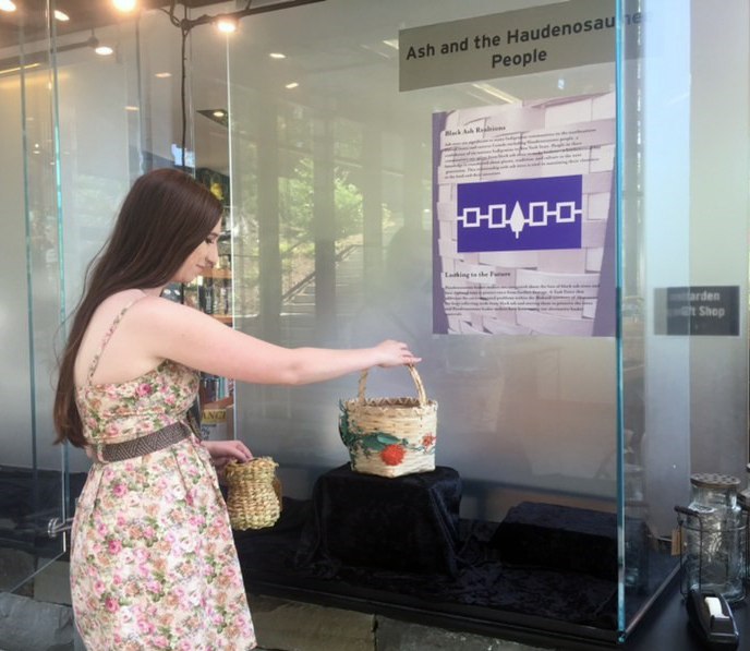 Caption: Hopkins-Hensley mounting her exhibit at the Cornell Botanic Gardens Nevin Welcome Center.