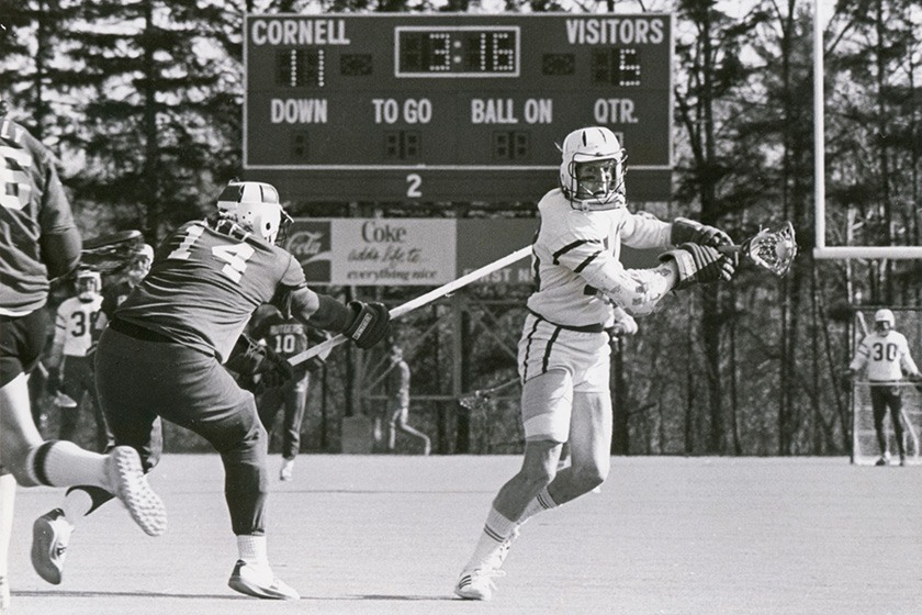 Two lacrosse players in action during a game