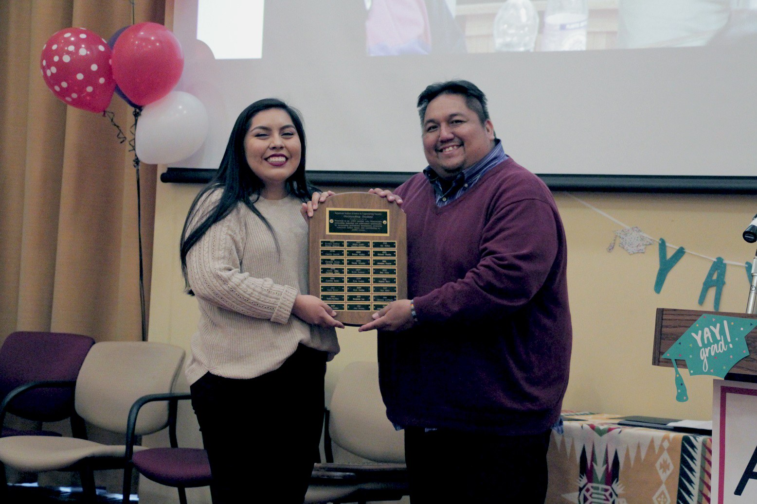 Julianne Billiman ’21 accepting an award from Vernon Miller, the former Residence Hall Director at Akwe:kon. Billiman, a Navajo student, is a recipient of the fund David Strip established to support indigenous students at Cornell. She received the 2019 American Indian Science and Engineering Society (AISES) Award.