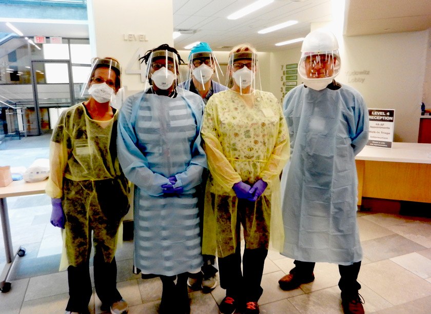 Members of Cornell Health’s pandemic operations team dressed in PPE to evaluate patients with COVID-19 symptoms. (L to R): Jamie Warner, licensed practical nurse; Dr. Jada Hamilton, assistant medical director; Kara Timmins, certified physician assistant; Penny Lamphier, licensed practical nurse; and Dr. Ed Koppel, assistant medical director.