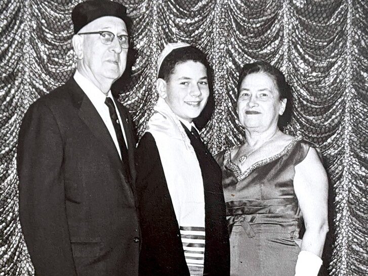 Kram at his Bar Mitzvah in 1963, with his grandparents, Anna and Hyman Greenberg.