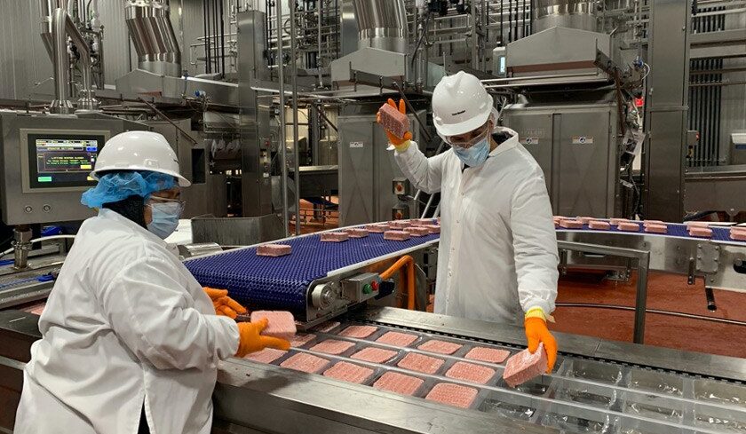 Dennis Woodside working on the Impossible Foods production line in Oakland, where his company makes plant-based meat.