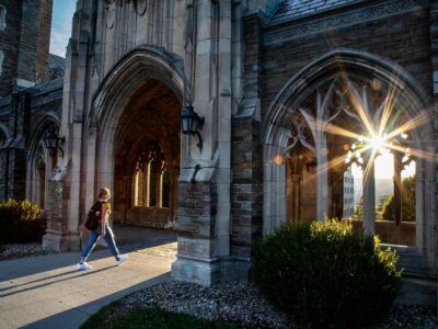 Students walk through campus in the early evening.