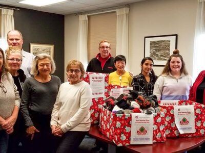 Cornell Club of Ithaca members participate in a sock drive in January 2020.