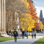 Students walk through campus in the fall