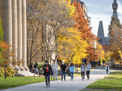 Students walk through campus in the fall