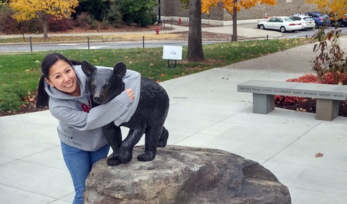 Rebecca Lee ’02 hugs Touchdown on a 2015 visit to campus for the Cornell China Conference.