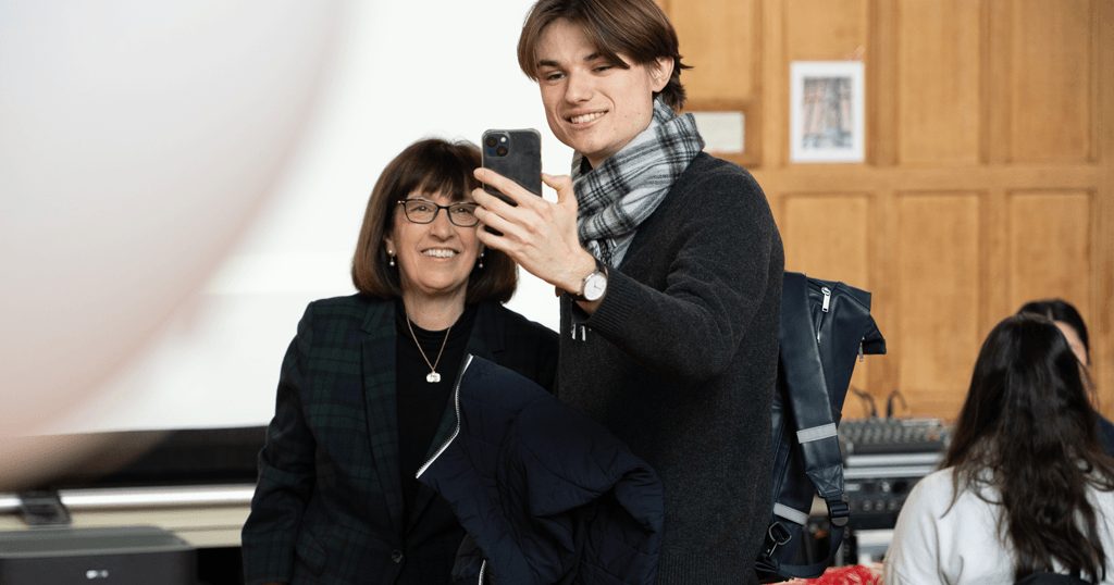 President Martha E. Pollack takes a photo with a student during Giving Day