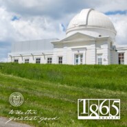 student walks by Fuertes Observatory in spring