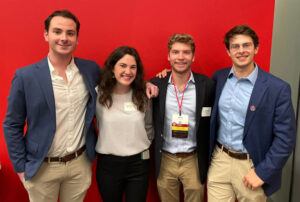 Seniors Luke Denver-Moore, Abigail Boatmun, Daniel Morgan, and Gabe Schiffer attending a student networking event with trustees and Cornell leaders during TCAM