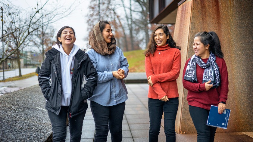 Tamana Ahmadi, Sepehra Azami, Diana Ayubi, and Simah Sahnosh walk outside Uris Hall. They are among nine Afghan undergraduates who arrived on campus in December 2021.