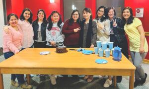 Several Afghan students and a graduate student mentor gathered to celebrate a birthday in spring 2022.