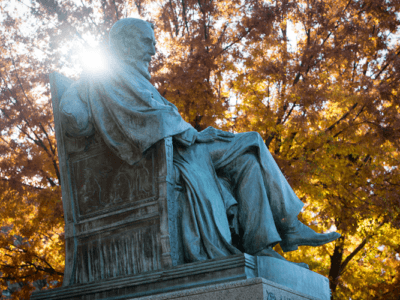 The statue of AD White on the Arts Quad in fall