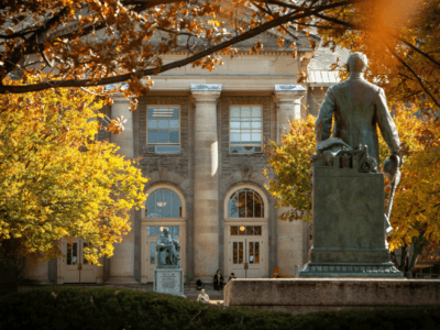 Goldwin Smith Hall and the statue of Ezra Cornell on the Arts Quad in fall