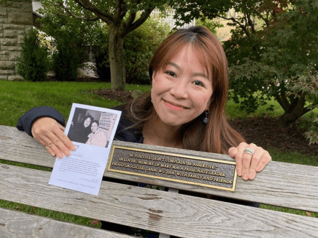 tanni wu holding a photo of her mother at a bench dedication
