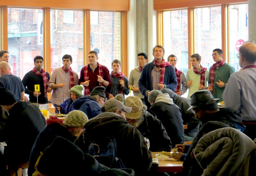 A Cornell Club of Oregon “Cornell Cares” event at The Blanchet House, serving homeless individuals in Portland, with the Cayuga Waiters in 2014. The singers are wearing the Cornell Tartan scarf made by Pendleton.