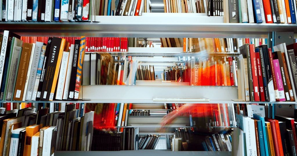 Student explores bookshelves in the Fine Arts Library