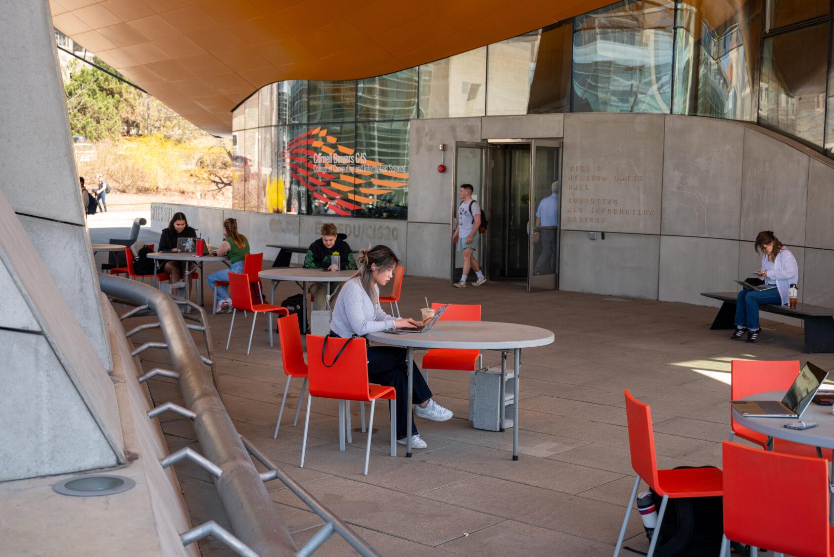 Students work on the plaza outside Gates Hall.