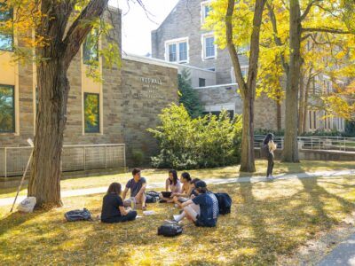 A class meets outside Ives Hall on a warm fall day.