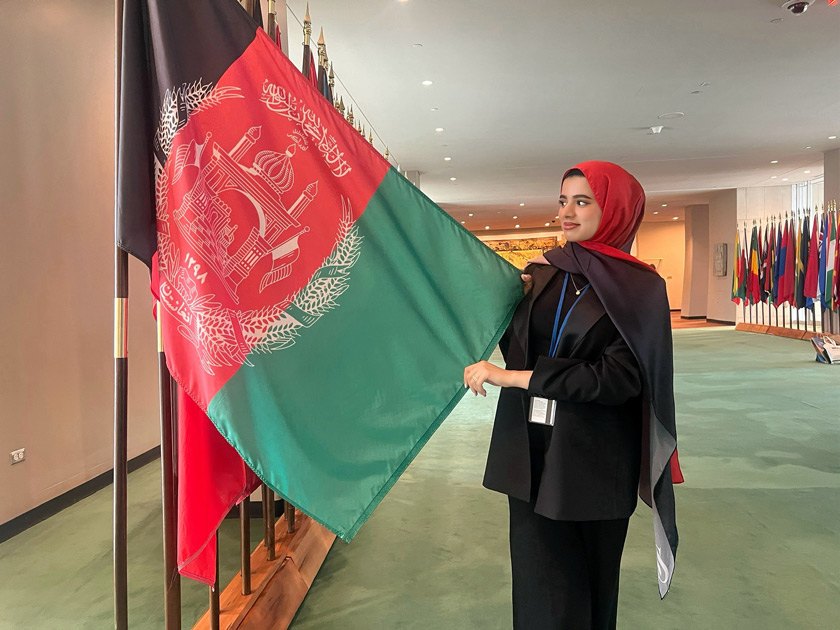 Mursal holds the Afghanistan flag, one of 195 flags that fly outside the UN Headquarters in NYC.