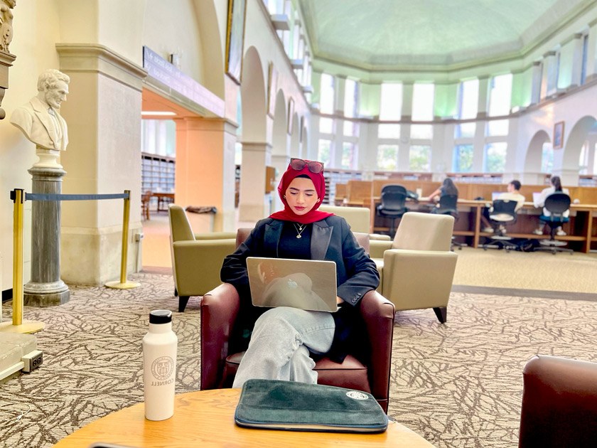 Mursal hard at work in the atrium of Uris Library at Cornell