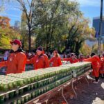 Members of NYC Cornellians provide handing out water cups at the 2024 New York City Marathon.