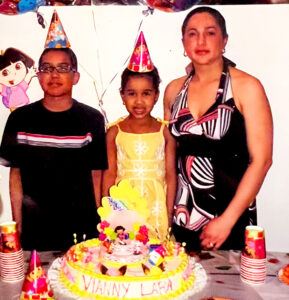 Vianny (center) celebrates her fifth birthday with her brother Saury Lara (left) and their mother Bianesa (right).