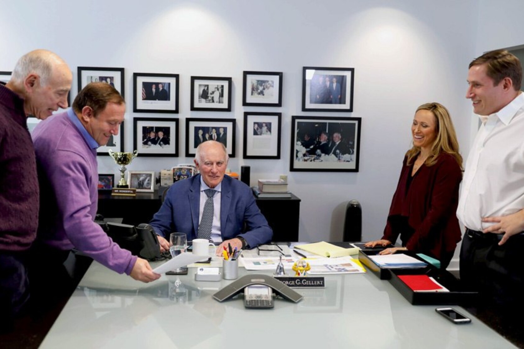 (L to R) Robert, Andy, George, Amy, and Tom Gellert meet in the Gellert Global Group office.