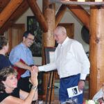 George Gellert ’60, MBA ’62, JD ’63 (right) congratulates Martin Wiedmann PhD ’97 (left in blue shirt) at a 2017 event dedicating the Gellerts’ gift to establish the Gellert Family Professorship in Food Safety.