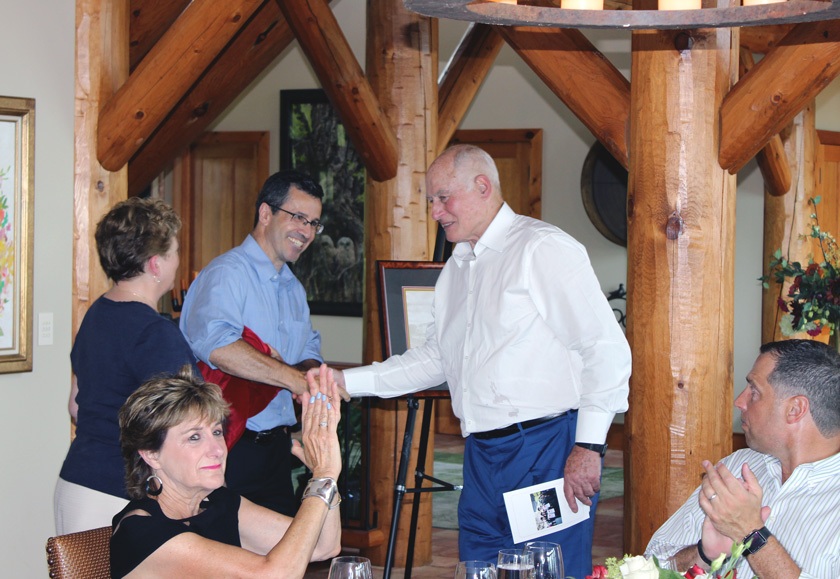 George Gellert ’60, MBA ’62, JD ’63 (right) congratulates Martin Wiedmann PhD ’97 (left in blue shirt) at a 2017 event dedicating the Gellerts’ gift to establish the Gellert Family Professorship in Food Safety.