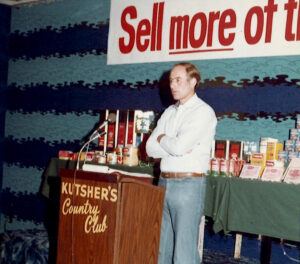 George Gellert at a company leadership conference in the 1970s, talking with team members about meeting and setting sales strategy.