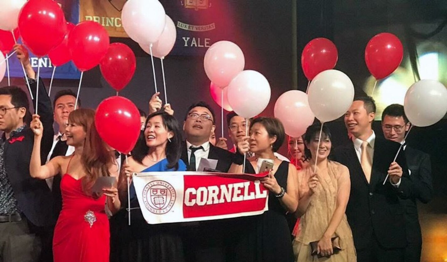 Isaac Wong '00 (2nd from right in gold tie) and his wife Cecilia (in gold dress) join other Cornellians at the 2017 Ivy Ball at the Hong Kong Convention Center.