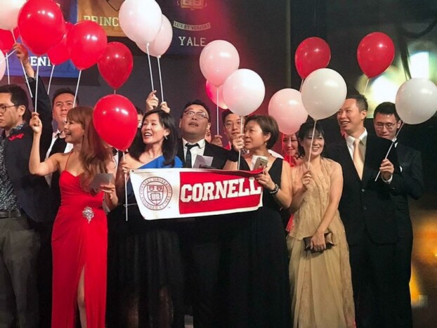 Isaac Wong '00 (2nd from right in gold tie) and his wife Cecilia (in gold dress) join other Cornellians at the 2017 Ivy Ball at the Hong Kong Convention Center.