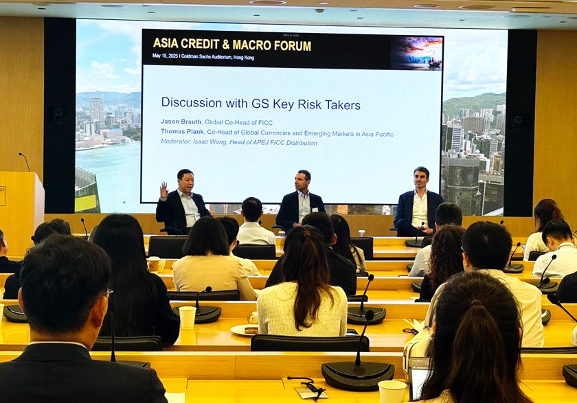 Isaac (left) hosting a client forum with his Goldman Sachs colleagues in May 2025