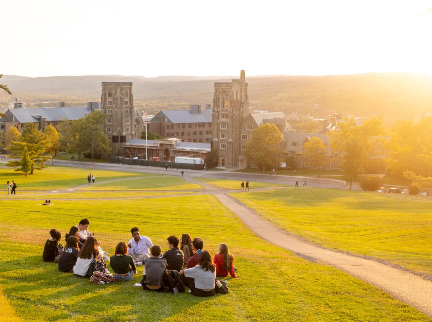 Students take in a fall sunset on Libe Slope.