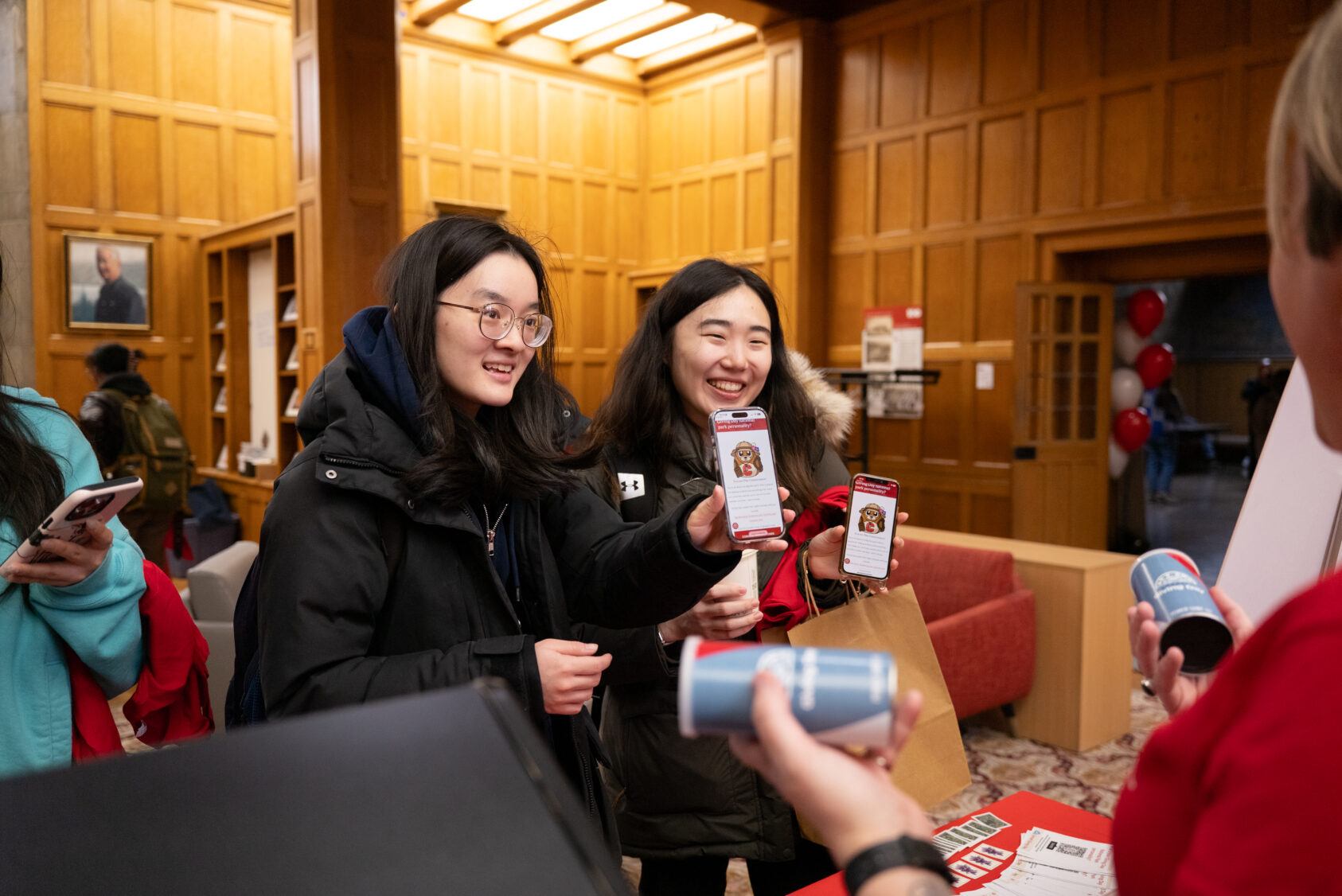 Students showing that they had completed the digital Giving Day scavenger hunt on their phones.